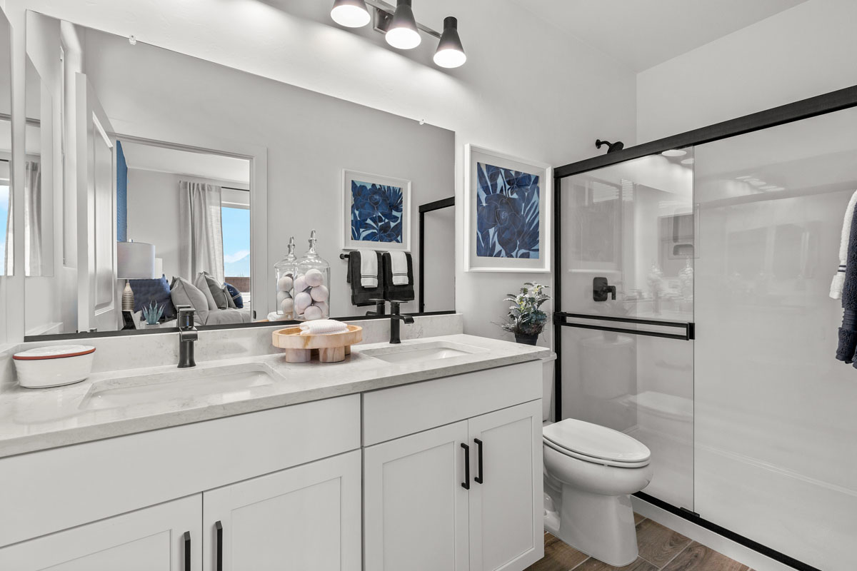 Walk-in shower with marble surround at primary bath