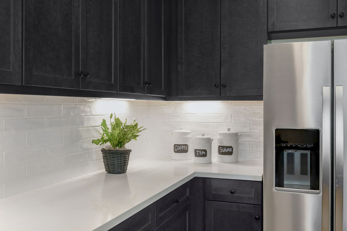 Upgraded quartz countertops with full tile backsplash