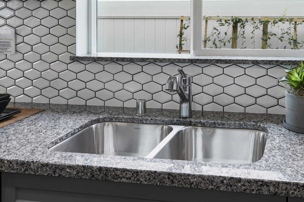 Granite countertops and double basin sink at kitchen