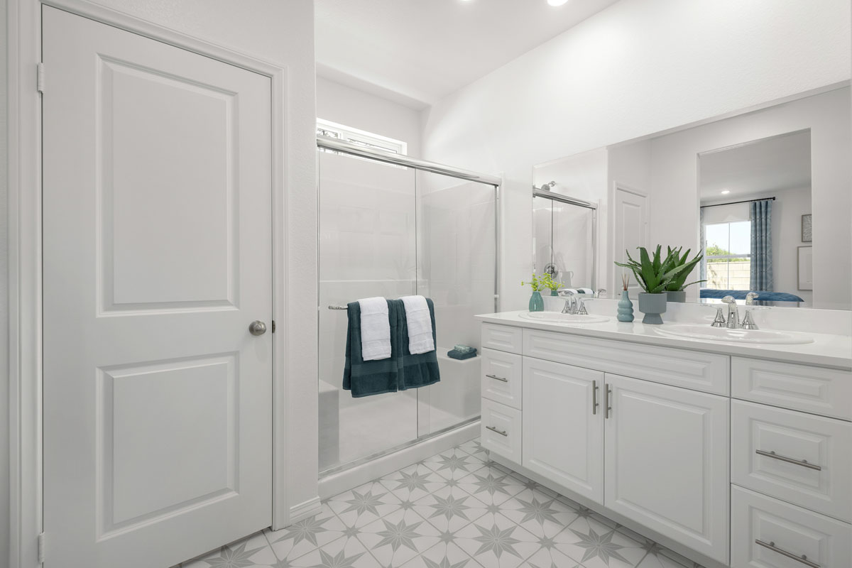 Walk-in shower and linen closet at primary bath