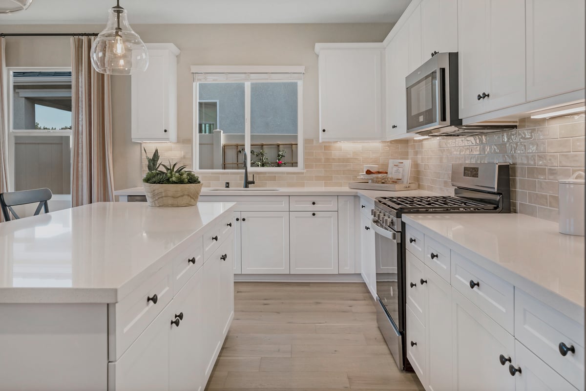 Optional quartz kitchen countertops and custom tile backsplash