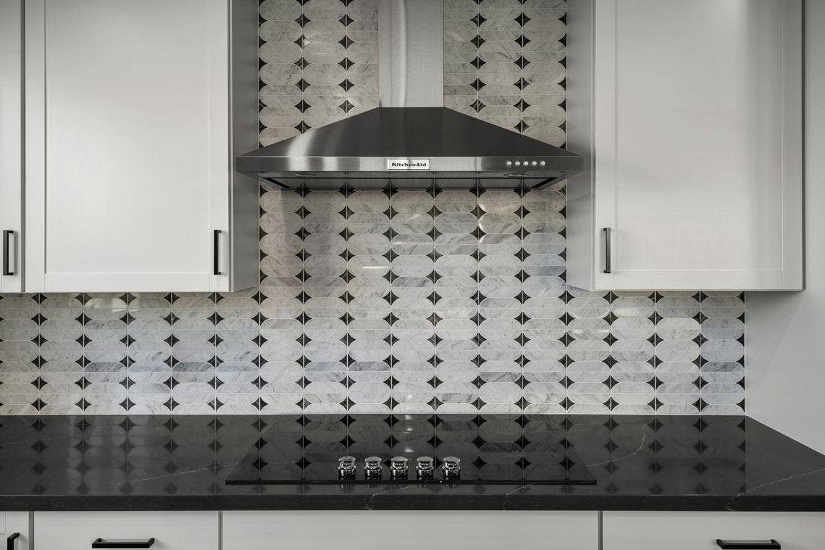 Wall-mounted hood over cooktop 