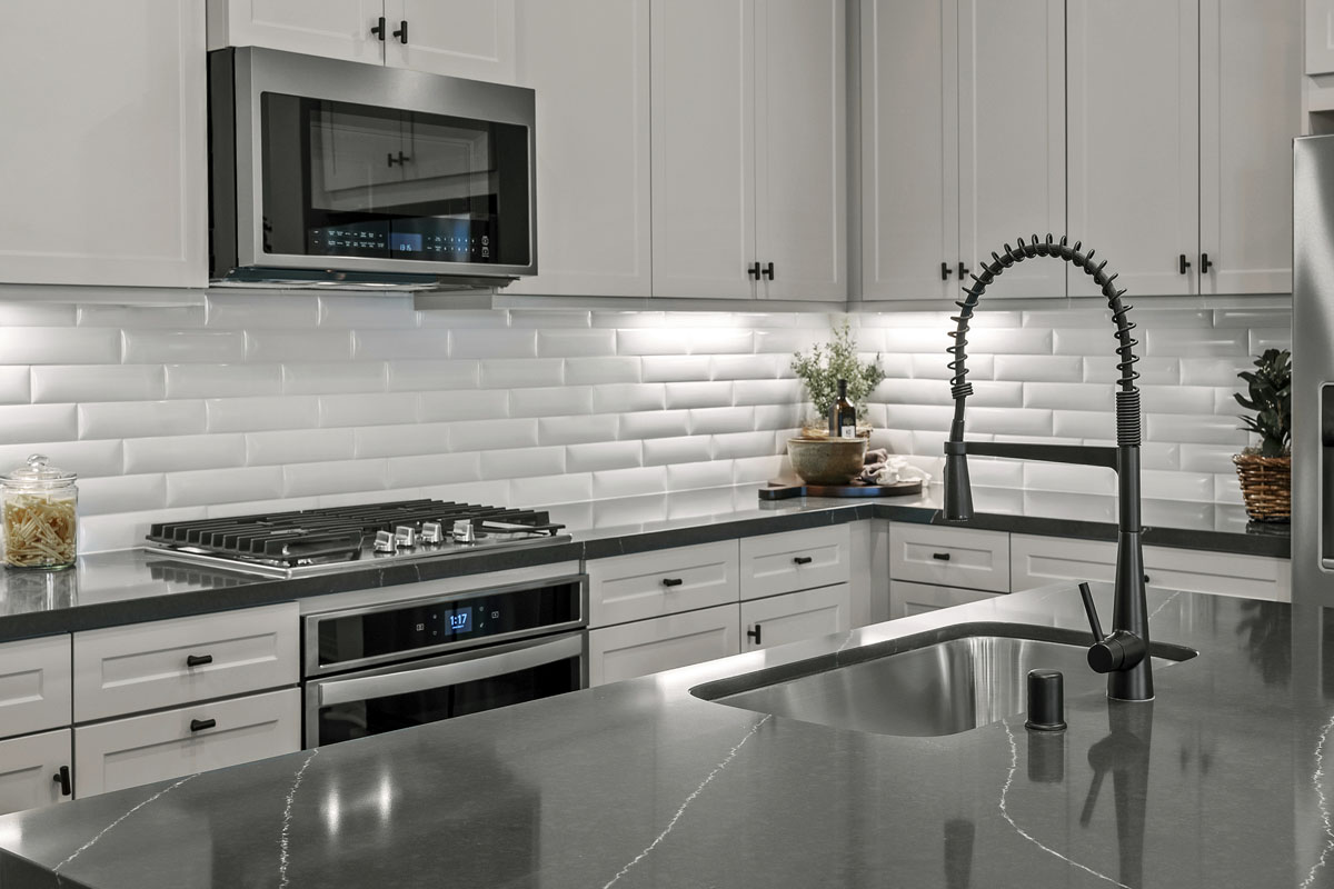 Upgraded quartz kitchen countertops and tile backsplash