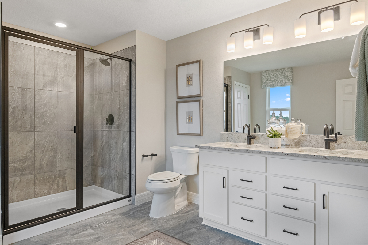 Walk-in shower with tile surround at primary bath 