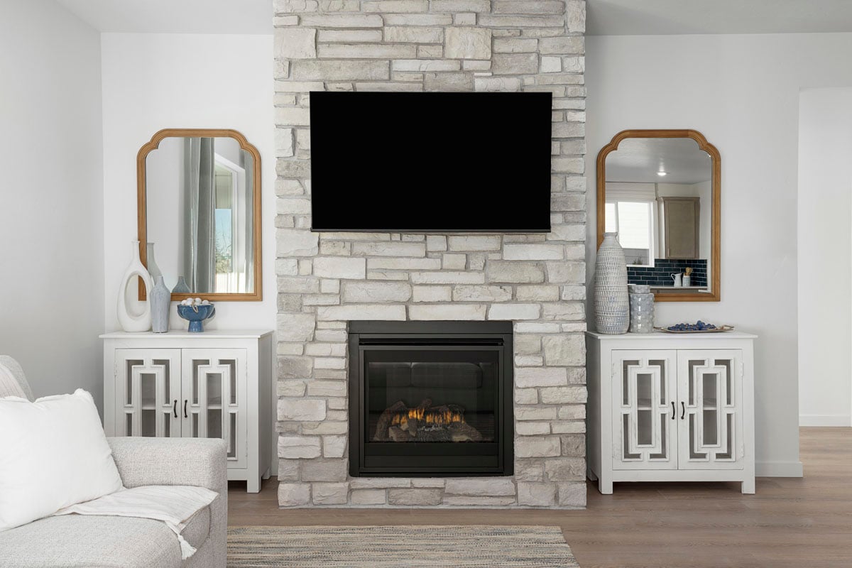 Gas fireplace with stone surround at great room