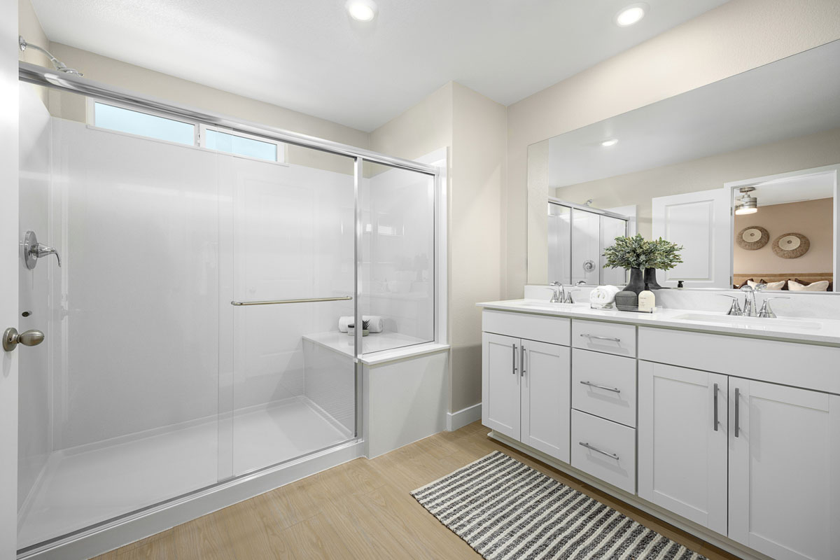 Enlarged walk-in shower with seat at primary bath