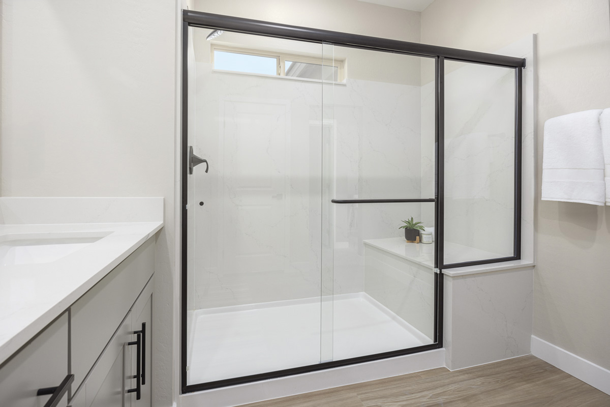 Enlarged walk-in shower with seat at primary bath