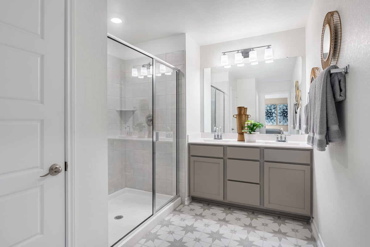 Walk-in shower with tile surround at primary bath