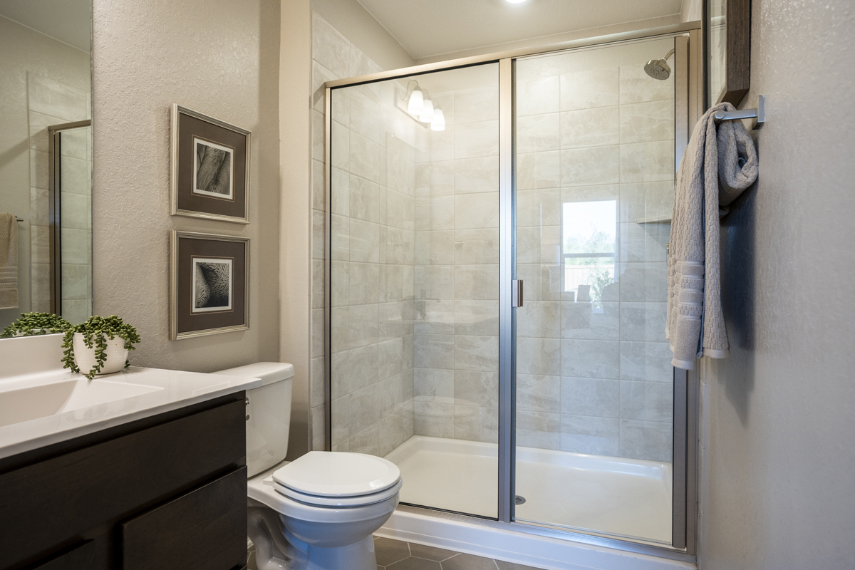 Walk-in shower with tile surround at primary bath