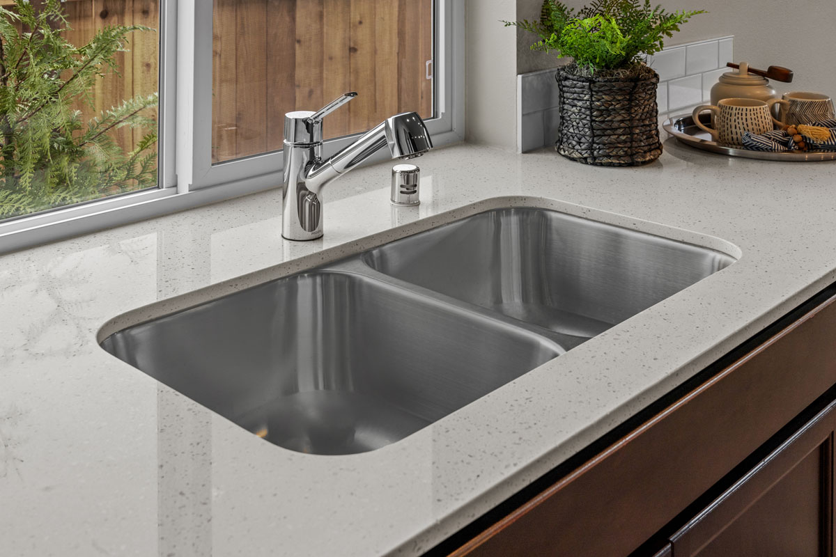 Stainless steel double-basin undermount sink at kitchen