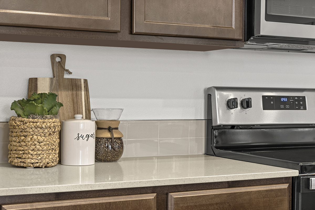 Quartz countertops and tile backsplash